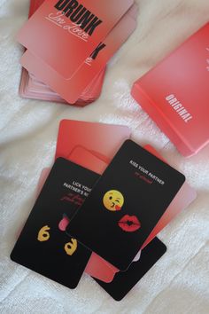 four cards with different emoticions on them sitting on a white blanket next to each other