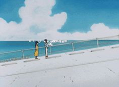 two people standing on the edge of a pier looking out at the water and clouds