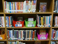 the bookshelves are filled with many different types of books and baskets on them