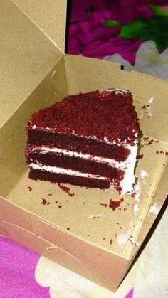 a piece of red velvet cake in a box