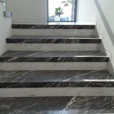 marble steps leading up to a window in a building