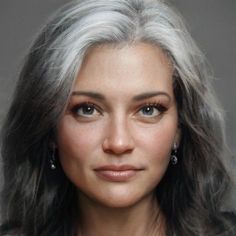 a woman with grey hair and earrings on