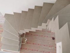 an overhead view of a stair case in a house under construction with tile on the floor and walls