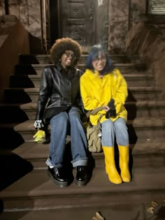 two women sitting on steps with yellow boots