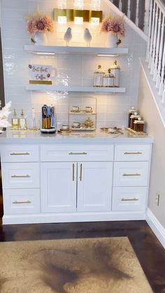 a white and gold bathroom with open shelving