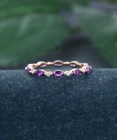 an image of a wedding ring with purple stones