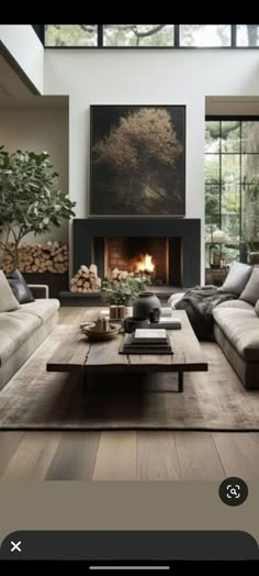 a living room filled with furniture and a fire place in the middle of a room