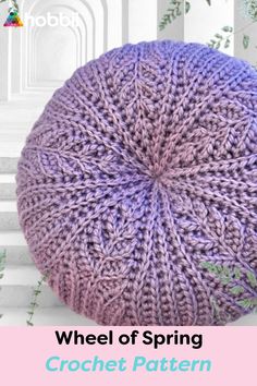 a purple knitted beanie with the words wheel of spring crochet pattern on it