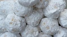 a pile of powdered donuts sitting on top of a table