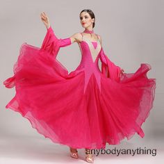 a woman in a pink dress is dancing