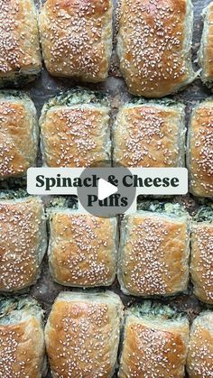 a bunch of bread rolls sitting on top of a pan filled with cheese and sesame seeds