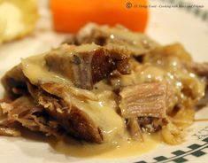 a white plate topped with meat and gravy