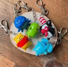 four keychains with different colored animals on them