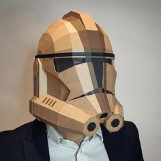 a man wearing a star wars mask made out of cardboard