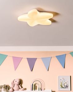 there is a teddy bear sitting on the shelf in this child's playroom