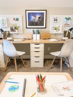 an office with two desks, chairs and pictures on the wall above them is shown