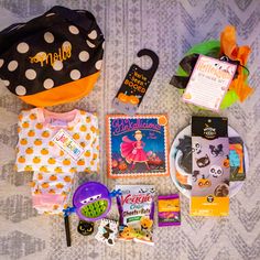 the contents of a child's halloween costume laid out on a bed with decorations