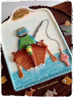 there is a cake that looks like a fisherman on a boat with fish in the water