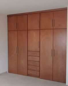 an empty room with wooden cabinets in it