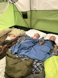 two babies are sleeping in a tent on the bed with their blankets folded over them