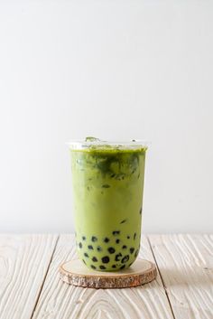 a green smoothie with black dots on it