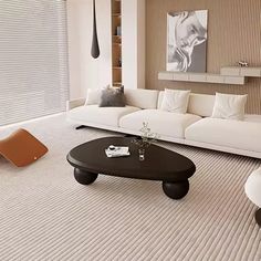 a modern living room with white furniture and neutral colors on the walls, carpeted flooring