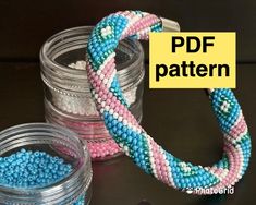 two jars filled with beads sitting on top of a table next to each other and the words pdf pattern above them