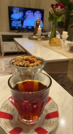 a glass cup filled with liquid sitting on top of a saucer