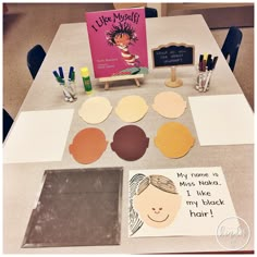 the table is set up with books and craft supplies for kids to use on their crafts