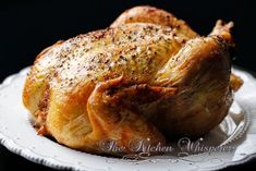 a roasted chicken on a white plate