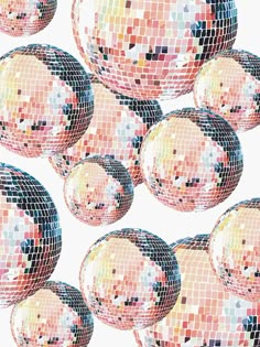 many shiny disco balls are arranged in the shape of a grid on a white background