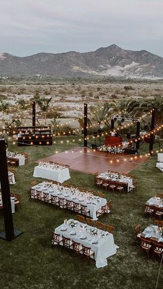 an outdoor venue with tables and chairs set up for a formal function in the desert