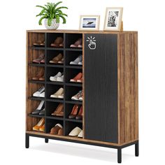 a shoe cabinet with many pairs of shoes on it and a potted plant next to it