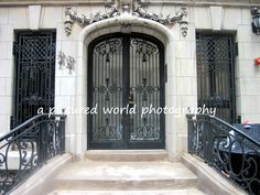 an entrance to a building with wrought iron doors