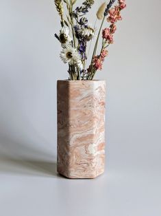 a vase with flowers in it sitting on a table