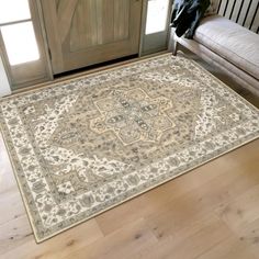 a large rug is on the floor in front of a door with a bench next to it