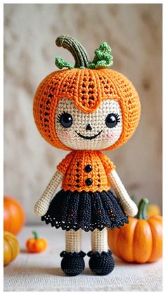 an orange doll is standing next to some pumpkins