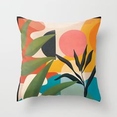 a pillow with an abstract painting on it's front and back sides, featuring leaves