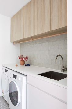 Pale timber overhead joinery with laundry hanging rail and sage green ceramic tile splashback in a white laundry Vinegar For Cleaning, Tiled Splashback, Using Vinegar To Clean, Cleaning Vinegar, Modern Family Home, Hanging Laundry, White Laundry, Joinery Design, Laundry Design