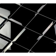 a black and white tiled wall with some mirrors reflecting it's reflection in the mirror