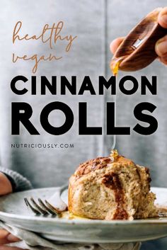 a person holding a plate with cinnamon rolls on it and the title reads healthy vegan cinnamon rolls