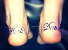 two feet with words written on them and the word hells down in cursive font