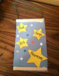 a small book with stars on it sitting on a wooden table next to a computer keyboard