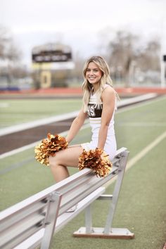 a cheerleader is posing on the bleachers