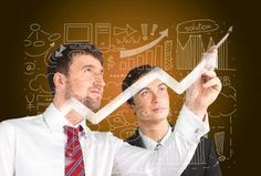 two business people looking at an upward graph