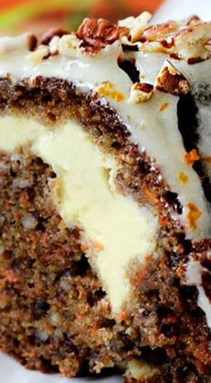 a piece of cake with white frosting and nuts on top