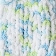 a crocheted blanket with blue, green and white colors