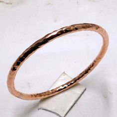 Hammered Solid Pure Copper Bangle, copper Bracelet, Solid Copper bangle, Healing Arthritis Copper Bangle, Bridesmaids Gift Handmade item Materials: Copper Adjustable : No Style: Minimalist Bracelet Size Inches Circumference/Diameter 7 / 2.23 7.5 / 2.39 8 / 2.55 8.5 / 2.71 9 / 2.87 9.5 / 3 Elegant, , minimal and shiny ! A lovely basic to have in your wardrobe and wear anytime  O T H E R ∙ I N F O R M A T I O N * All items are nicely packaged ready to gift in elegant jewelry boxes. Please store your jewelry away from humidity, the best place being in a jewelry box  IMPORANT NOTE ON BANGLE SIZES  Please see the photo in the listing that shows how to measure for your bangle size. Your bangle size is determined more by the size of your hand than your wrist. To find out your bangle size, simply Handmade Copper Bangle Bracelets, Hand Forged Copper Bangle Bracelet, Hammered Rose Gold Bangle, Rose Gold Metal Round Bangle, Hammered Copper Bangle Bracelets, Hammered Copper Bangle Bracelet, Gold Electroformed Bracelets For Gift, Rose Gold Bangle Bracelets For Jewelry Making, Rose Gold Copper Bangle Cuff Bracelet