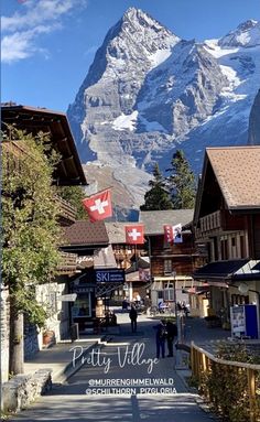 the mountains are covered in snow and there is a sign that says, city village