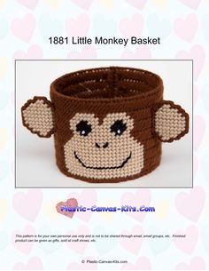 a small monkey head on top of a brown knitted basket